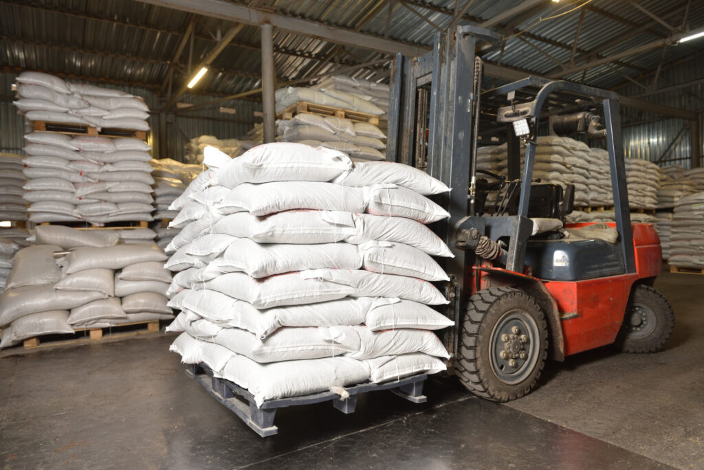 Forklift transporting sugar sacks inside a warehouse – Fasana commodity logistics